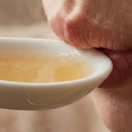 Sipping the soup from a spoon
